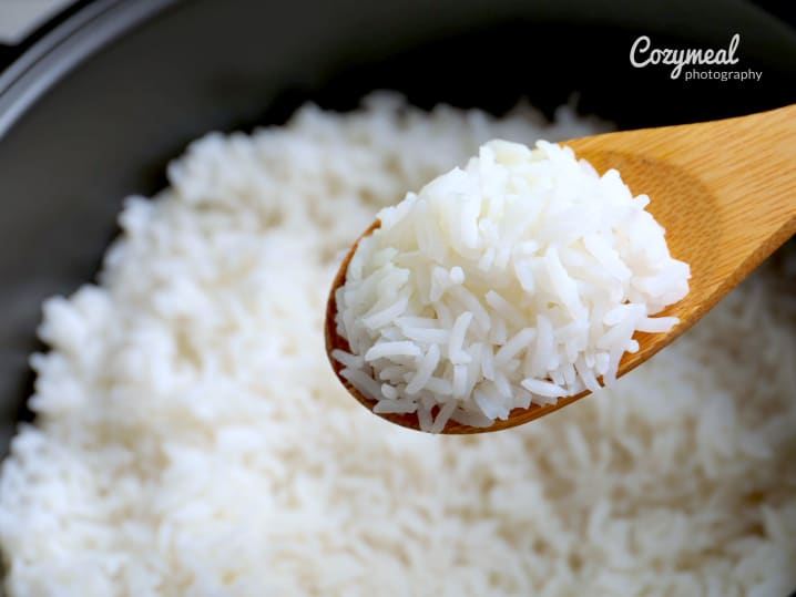 steamed rice on a wooden spoon