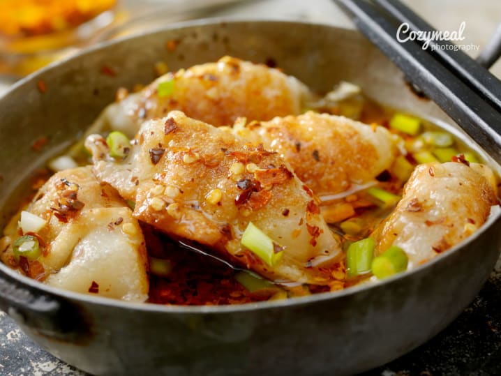 steamed dumplings coated in chili scallion sauce