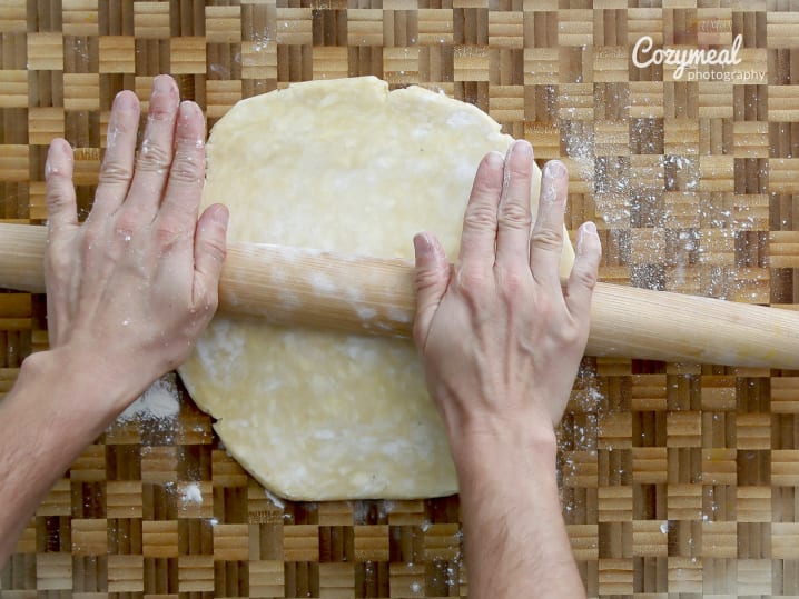 using wooden roller to roll out puff pastry dough