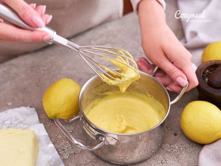 whisking Hollandaise sauce in a small pot