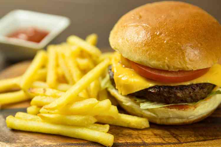 Burgers served with fries on a wooden table