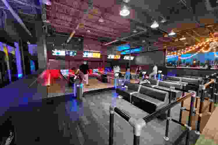 a bowling alley with wood floors and streamer lights