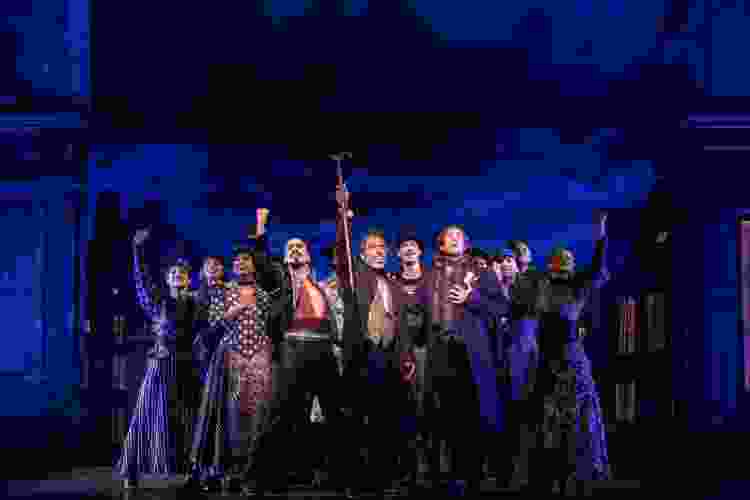 a troupe of actors onstage during a Les Miserables performance