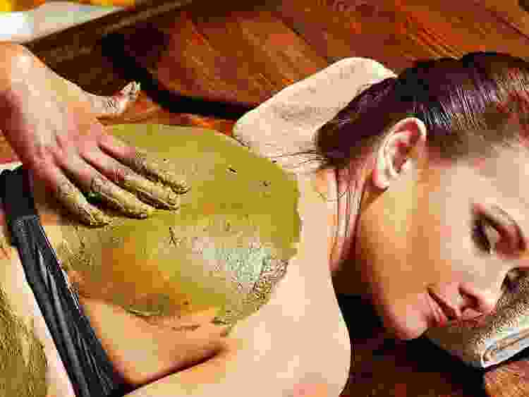 woman at a spa getting a mud mask