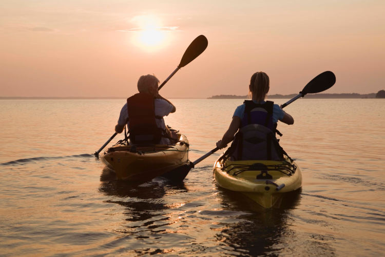 couple kayaking at sunset