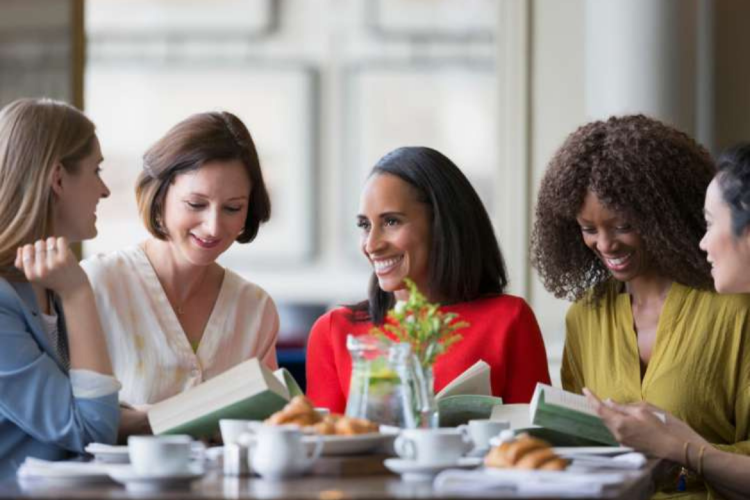 friends enjoying their books during a book club meeting