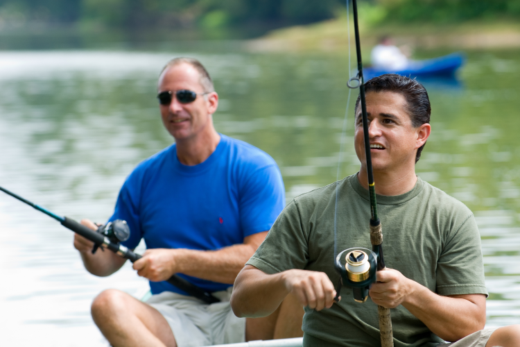 two men fishing on a boat for 40th birthday party idea