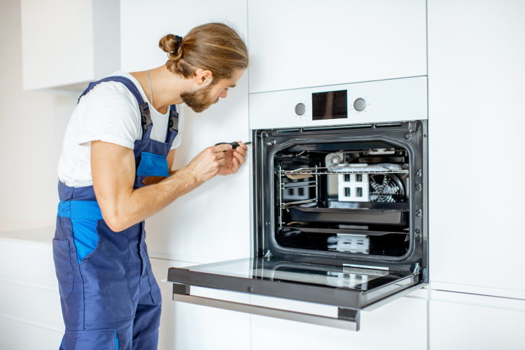 Man installing white oven