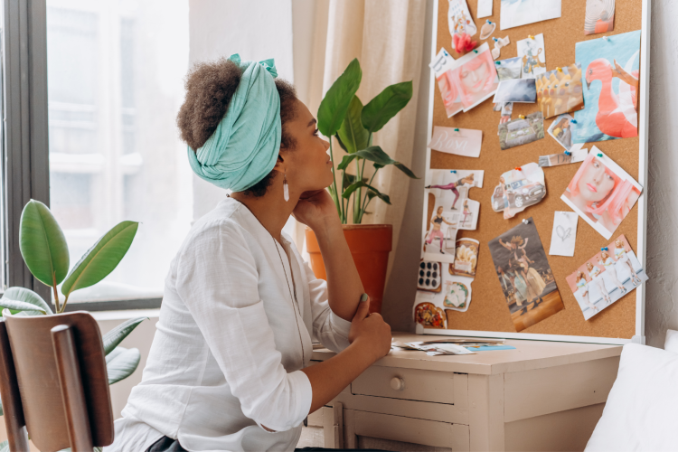 young woman admiring her cork memory board DIY gift idea