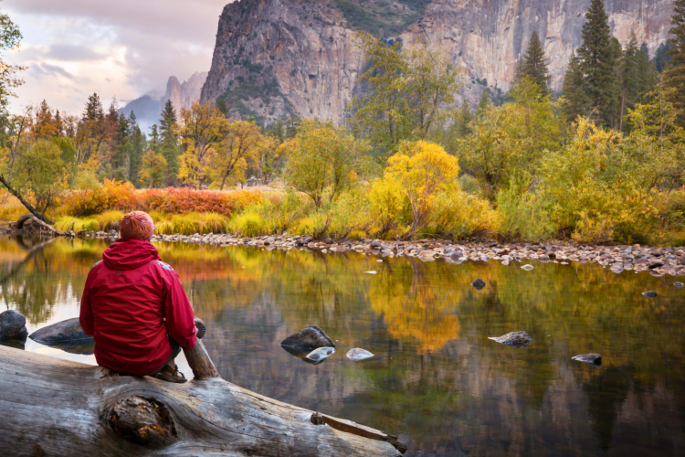 man overlooking autumn lake