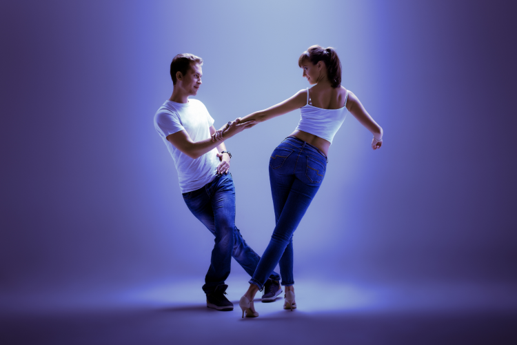 two dancers in spotlight