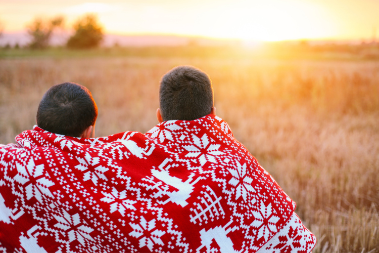 couple cozied up under holiday blanket