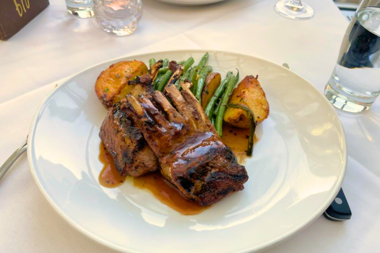 At this rooftop restaurant in Boston, try the rack of lamb ribs with roast potatoes.