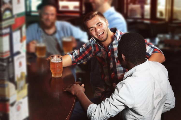 men drinking beer at a bar