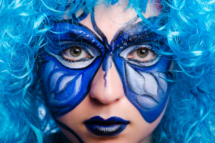 woman with face painted with butterfly