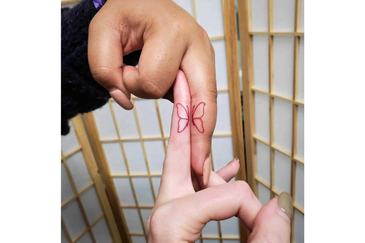 Butterfly wedding ring tattoo