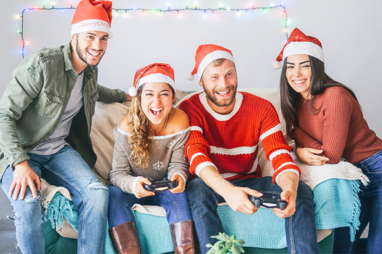 friends playing video games in Santa hats