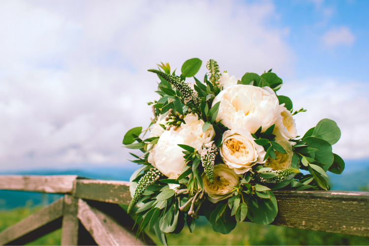 a eucalyptus and white roses wedding bouquet for this wedding theme