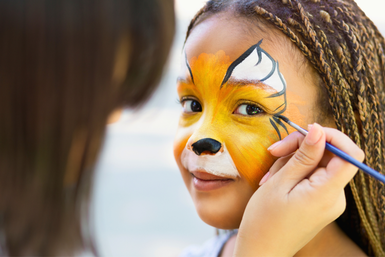 young girl with orange butterfly face paint