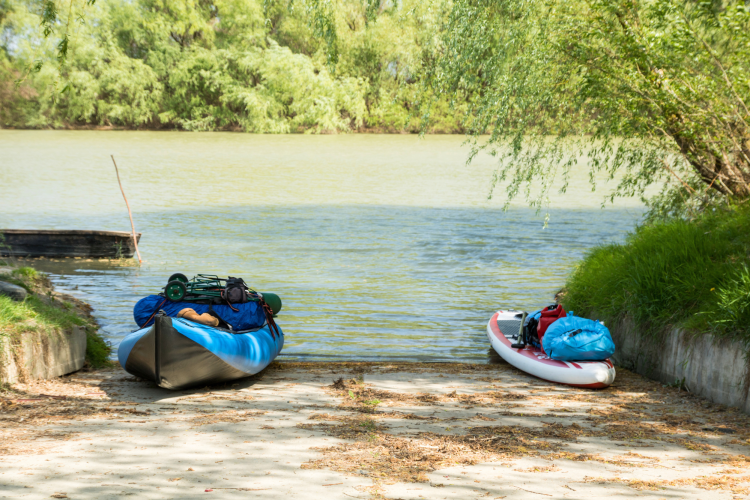 Folding kayaks next to river