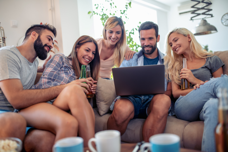 group of friends with laptop playing game