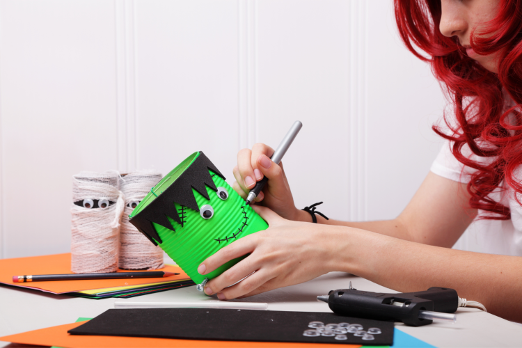painting Frankenstein monster on tin can