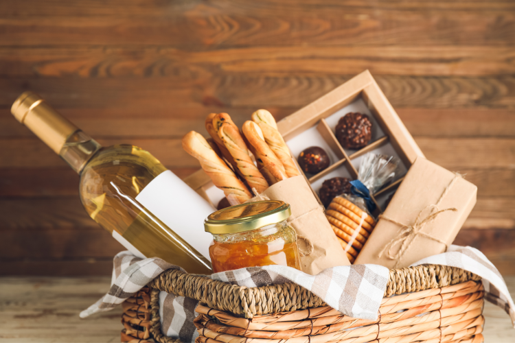 gift basket full of wine, cheese and other snacks