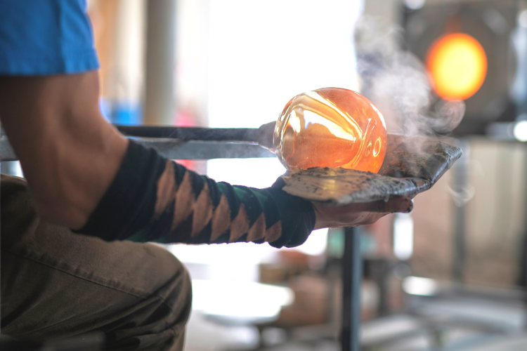 hand blowing orange glass art