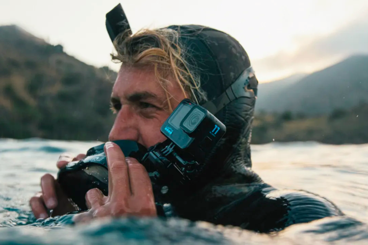 man in wetsuit with camera