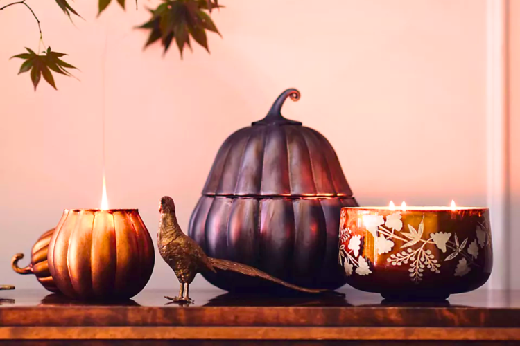 assorted pumpkin candles on a shelf