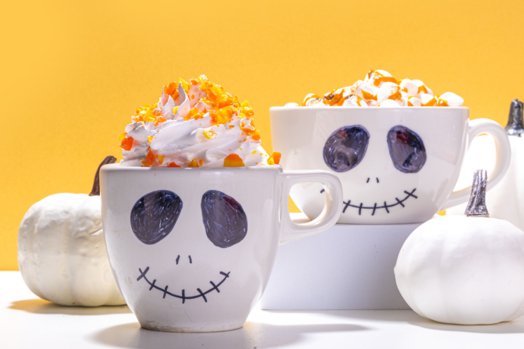 white coffee mugs with skeleton face painted on them