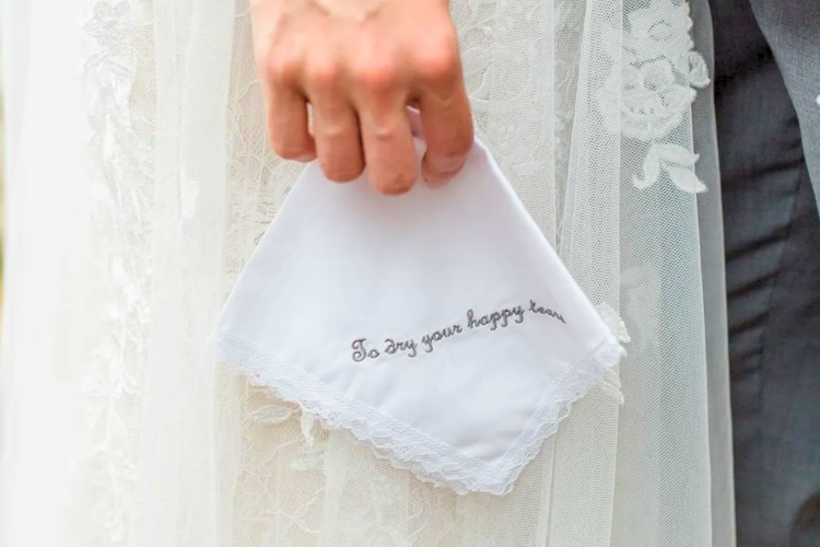 A hand-embroidered handkerchief is a personal mother of the groom gift idea.