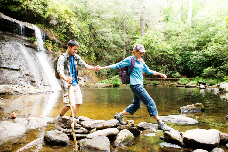 couple hiking near waterfalls
