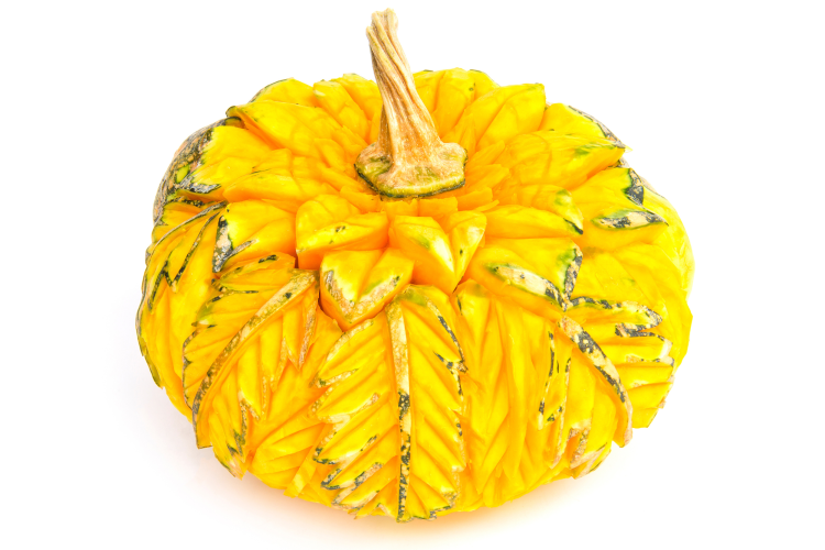 yellow pumpkin carved with intricate leaves