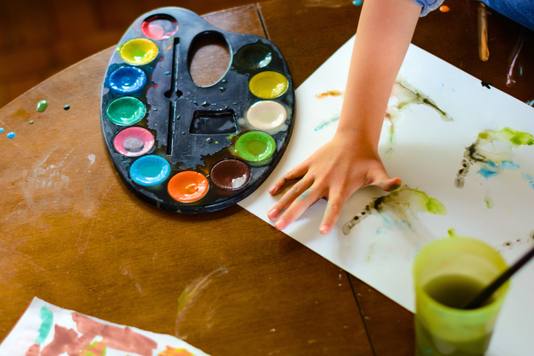 A child making hand print art is an easy craft idea.
