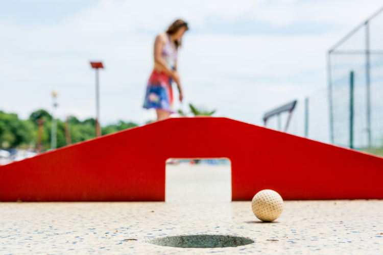 woman playing mini golf