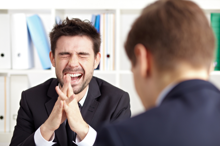 Man laughing at a one liner joke for adults