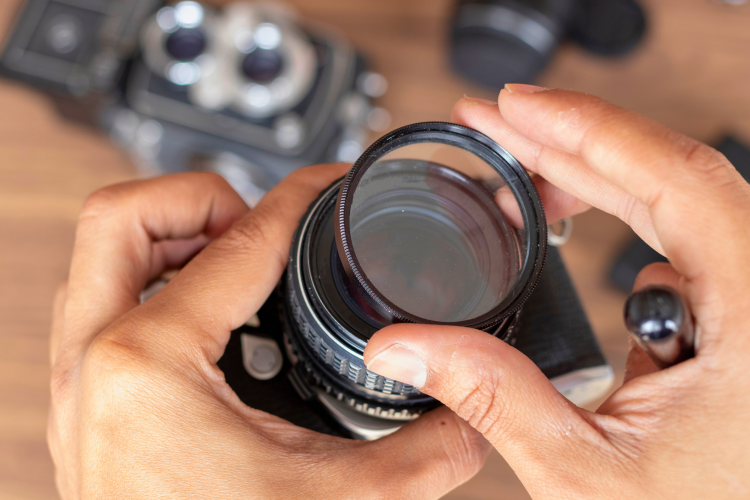 Person placing a filter on a camera