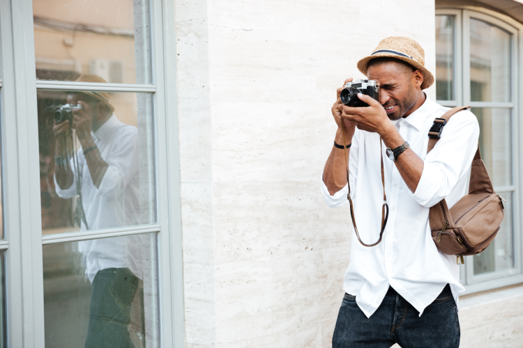 man taking photos with film camera