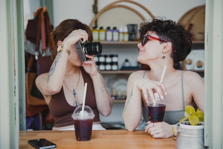 couple taking photos of each other in coffee shop