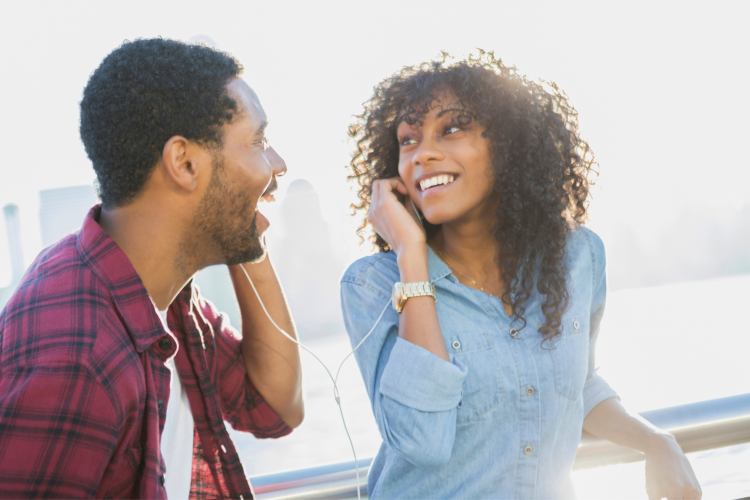 couple listening to earbuds together