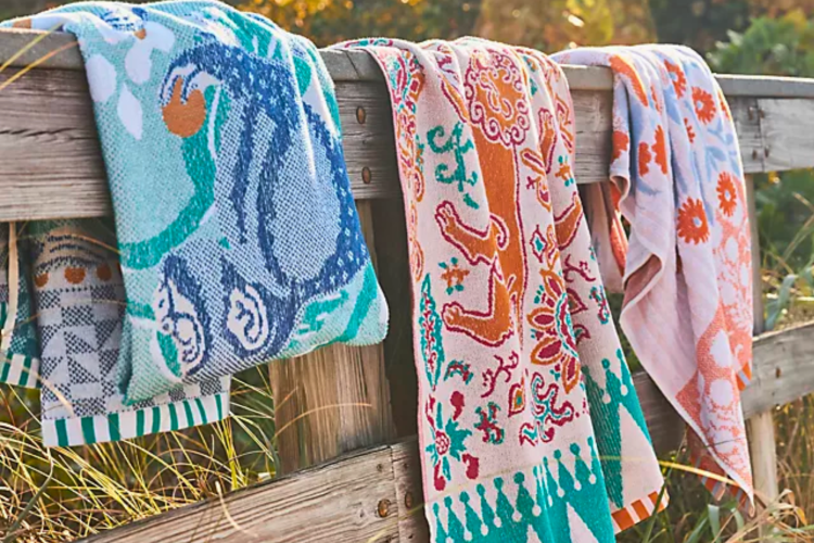 set of pretty beach towels hanging on the boardwalk