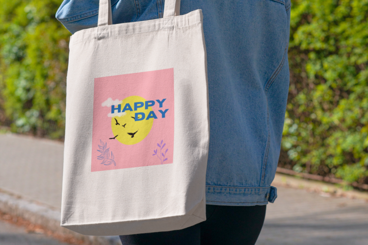 woman carrying tote bag that says