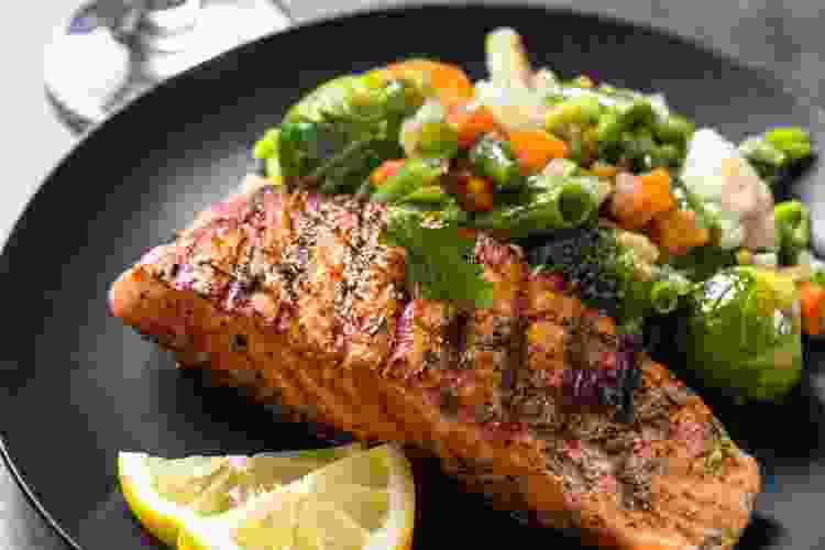 Grilled salmon fillet with vegetables on a plate