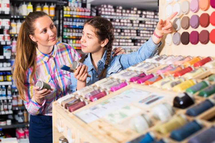 mother and daughter shopping at craft store for acrylic vs. oil paint