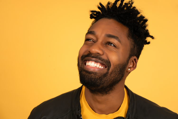 happy man smiling with bright yellow background