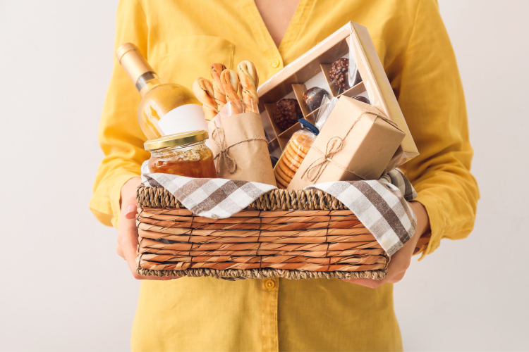gift basket filled with bread, chocolate, wine and other snacks