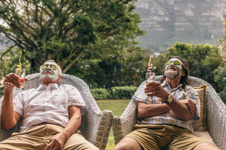 two men enjoying mud masks and cucumbers outside