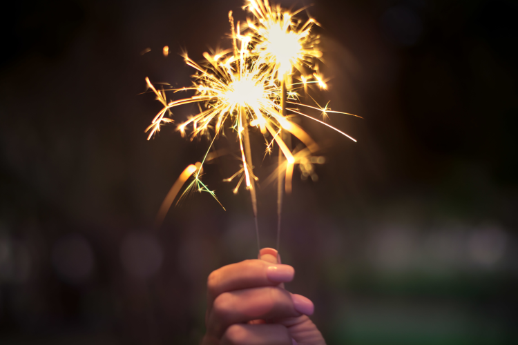 holding sparklers at night