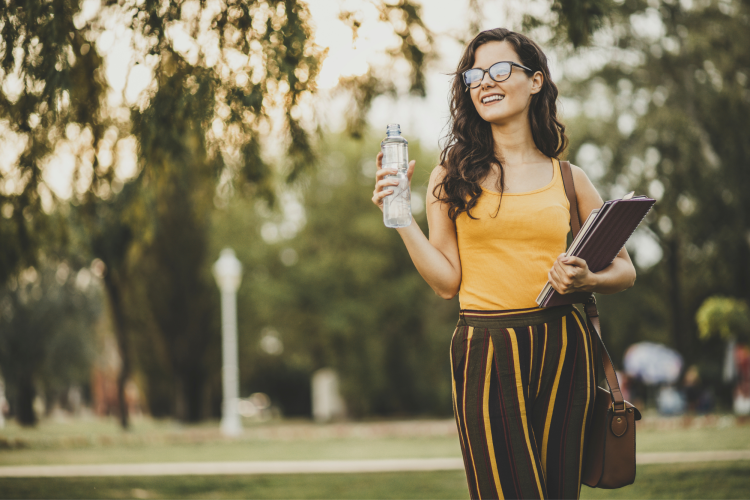 student drinking water on campus